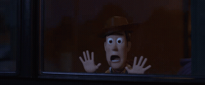 Woody From Toy Story Looking Out Of A Window With His Hands Up GIF