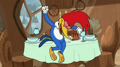 Woody Woodpecker Sitting At Table With Cake And Wine Glasses GIF