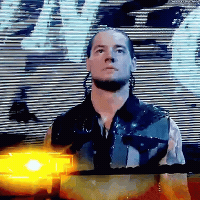 Wrestler Before Large Screen With Yellow Light Behind GIF