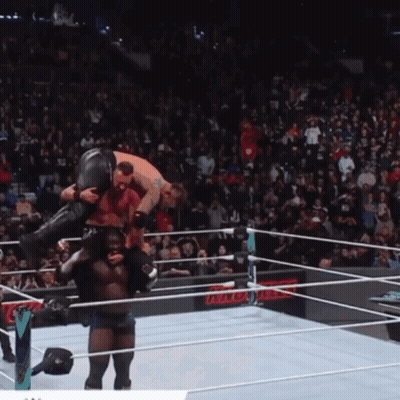 Wrestler Carrying Another Wrestler In Ring GIF