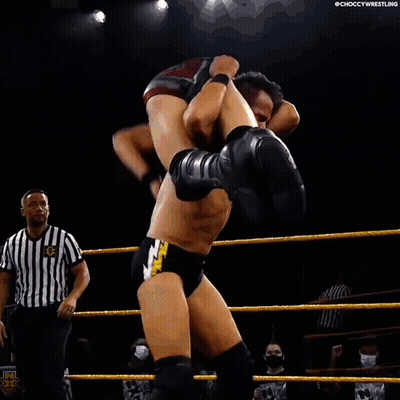 Wrestler Carrying Another Wrestler On Back In Ring GIF