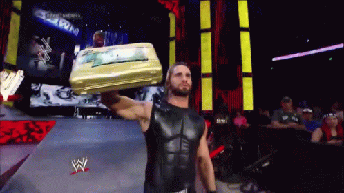 Wrestler Carrying Suitcase On Head GIF