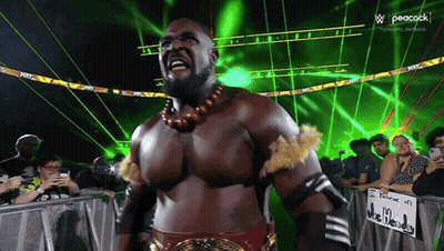 Wrestler Facing Crowd With Peacock Logo GIF