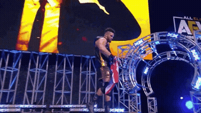 Wrestler Holding American Flag Stage Before Large Screen GIF