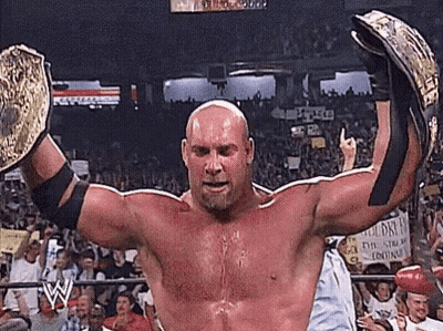 Wrestler Holding Championship Belts Before Crowd GIF