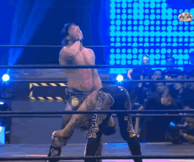 Wrestler Holding Opponent On Shoulders In Ring GIF