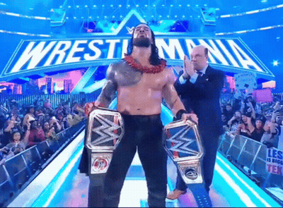 Wrestler Holding Two Championship Belts At WrestleMania GIF