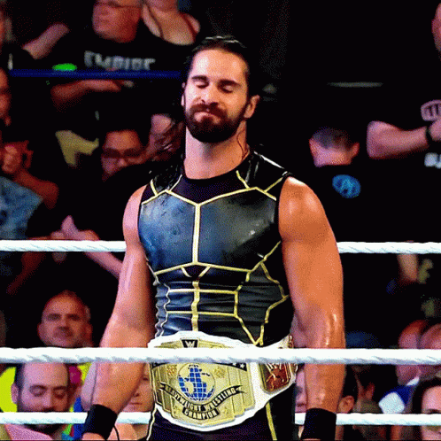 Wrestler Holding World Heavyweight Belt In Ring GIF