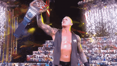 Wrestler Holding World Heavyweight Championship Belt Over Head GIF
