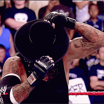 Wrestler In Black Hat With Undertaker Boxing Gloves GIF