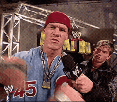 Wrestler In Blue Jersey #45 Speaking Into Microphone GIF