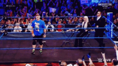 Wrestler In Blue Shirt Walking Out Of Ring GIF