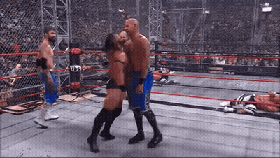 Wrestler In Blue Shorts Kissing Another Wrestler In Boxing Ring GIF