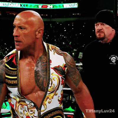 Wrestler In Front Of Wrestlemania Sign GIF