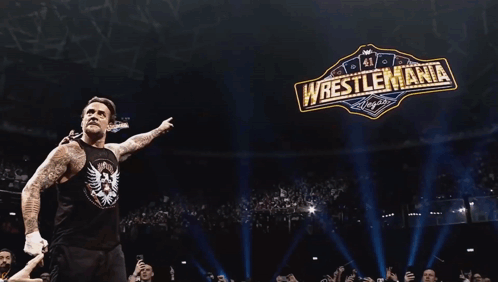 Wrestler In Front Of Wrestlemania Sign GIF
