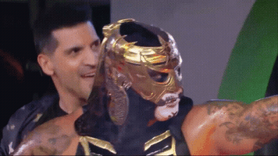 Wrestler In Gold Mask Held By Man GIF