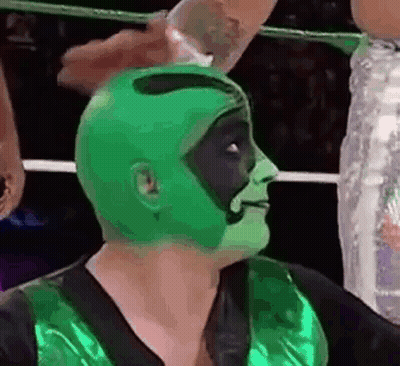 Wrestler In Green Mask Held By Another Wrestler GIF