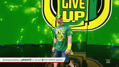 Wrestler In Green Shirt Saying Give Up GIF