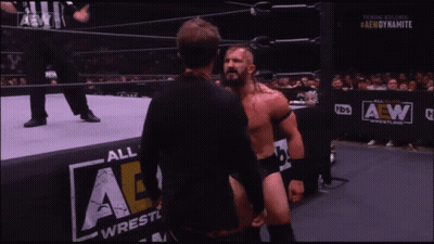 Wrestler In Mask Talking To Another Wrestler By AE Wall GIF