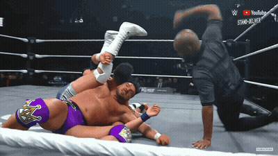 Wrestler In Purple Shorts Being Pinched GIF