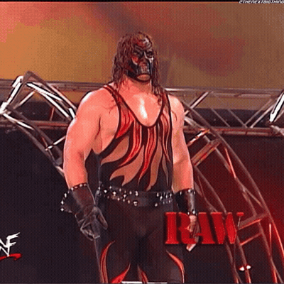 Wrestler In Red And Black In Front Of Stage GIF