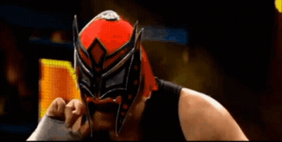 Wrestler In Red And Black Mask Holding Sword GIF