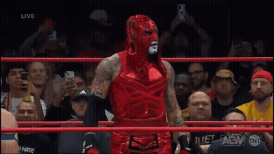 Wrestler In Red Mask With Arm In Air GIF