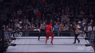 Wrestler In Red Outfit In Wrestling Ring With Crowd GIF