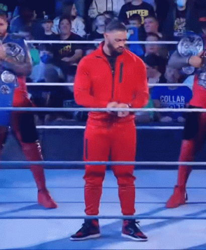 Wrestler In Red Suit Standing In Ring GIF