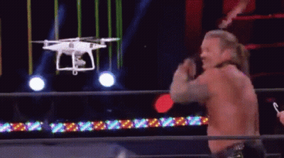 Luchador en ring con dron sobrevolando GIF