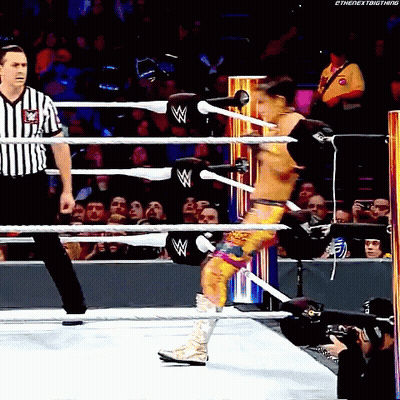 Wrestler In Ring With Referee Behind Him GIF
