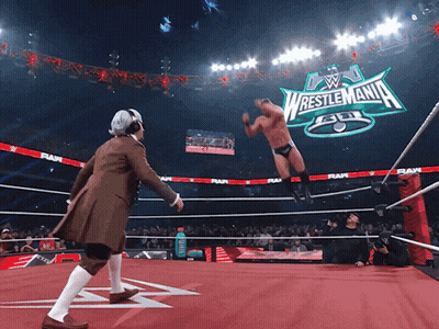 Wrestler In Ring With Wrestlemania Sign GIF
