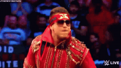 Wrestler In Sunglasses And Headband Walking On Stage GIF