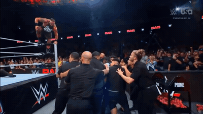 Wrestler Jumping In Air As Crowd Watches GIF