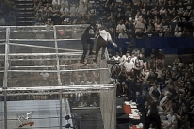 Wrestler Jumping Over Fence In Wrestling Ring GIF