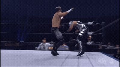 Wrestler Kicking Another in AEW Ring