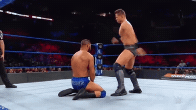 Wrestler Kneeling As Another Jumps In Ring GIF