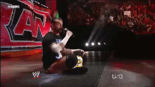 Wrestler Kneeling In Front Of Sign GIF