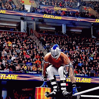Wrestler Kneeling In Ring In Front Of Crowd GIF