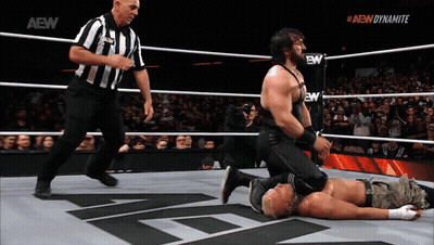 Wrestler Kneeling In Ring With AEW Dynamite Logo GIF