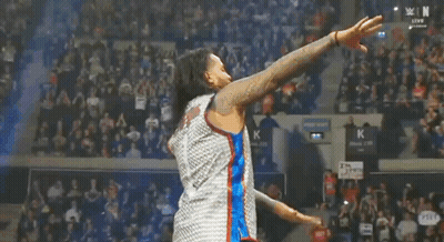 Wrestler Kneeling In Ring With Crowd Watching GIF