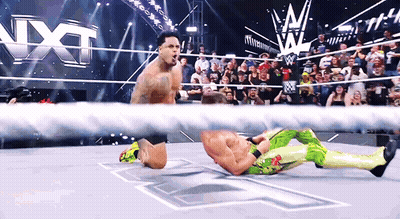 Wrestler Kneeling In Ring With Crowd Watching GIF