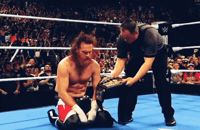 Wrestler Kneeling In Ring With Referee GIF