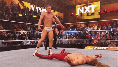 Wrestler Laying In Ring With NXT Sign GIF