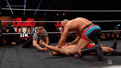 Wrestler Laying In Ring With Pirates UK Logo GIF