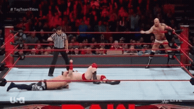 Wrestler Laying In Ring With Referee GIF