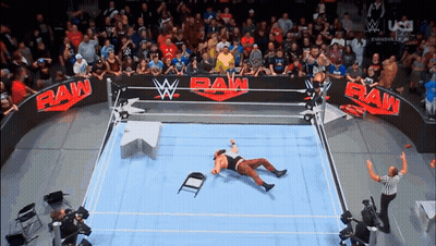Wrestler Laying On Floor In Raw Ring GIF