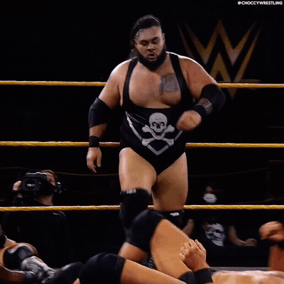 Wrestler Laying On Ground With Opponent Standing Over Him GIF