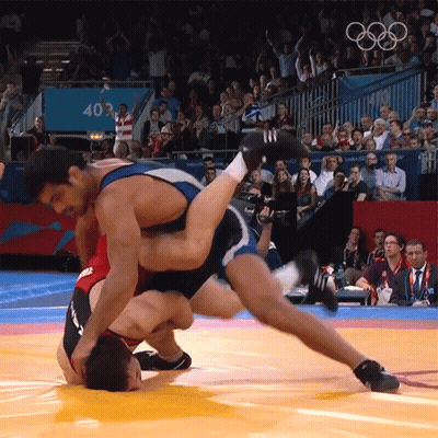 Wrestler Lifted By Another Wrestler In Front Of 403 Sign GIF