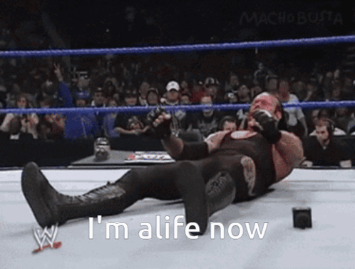 Wrestler Lying Down Saying Im Alive GIF